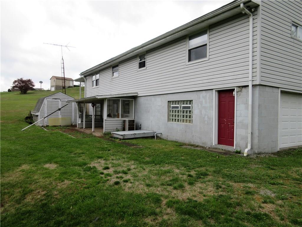 635 Fleming Road Sarver, PA 16055 - Photo 22 of 25 View of the back of the house, which has a 17' x 6' covered patio, 26' x 6' brick open patio, and a 16' x 10' shed.