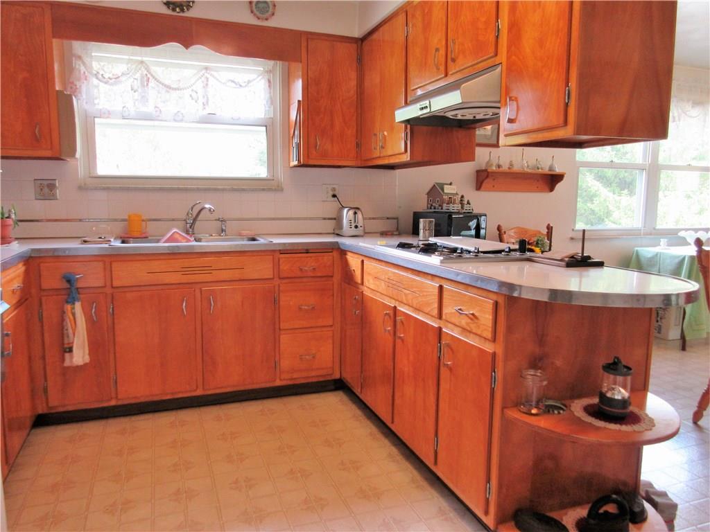 635 Fleming Road Sarver, PA 16055 - Photo 5 of 25 This kitchen is open to the dining room and features a ceramic tile back splash, double bowl sink, gas stove top, double oven, plus plenty of cabinets and counter space.