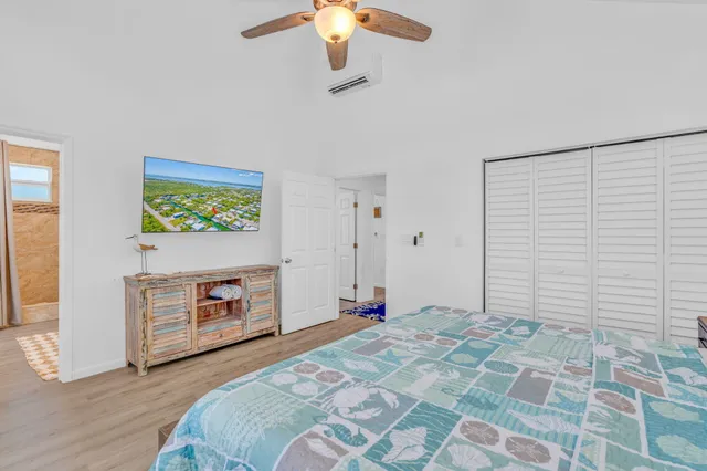 a bedroom with a bed and a chandelier