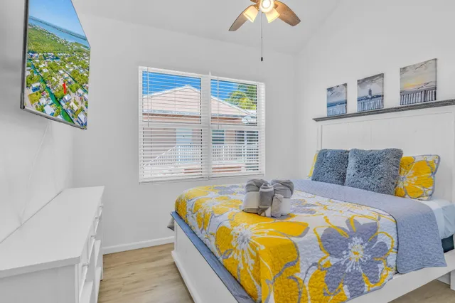 a bedroom with a bed and a chandelier