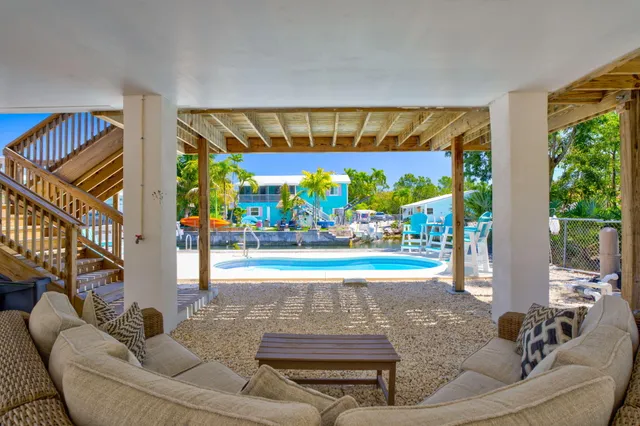 a living room with fireplace furniture and a floor to ceiling window