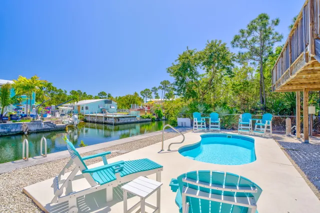 a view of a lake with couches chairs