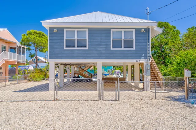 a view of a house with a yard and sitting area