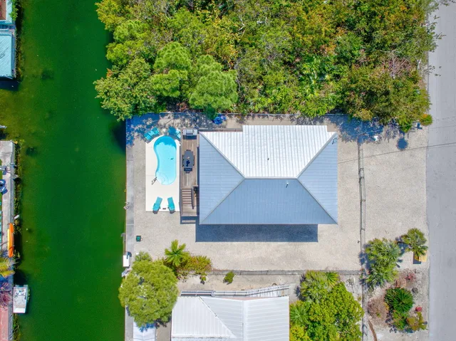 an aerial view of a house with a yard and garden