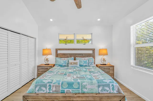 a bed sitting in a bedroom next to a window