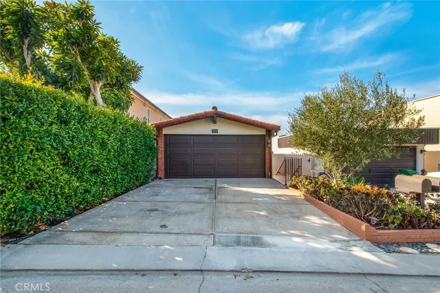 a front view of a house with a yard and a garage