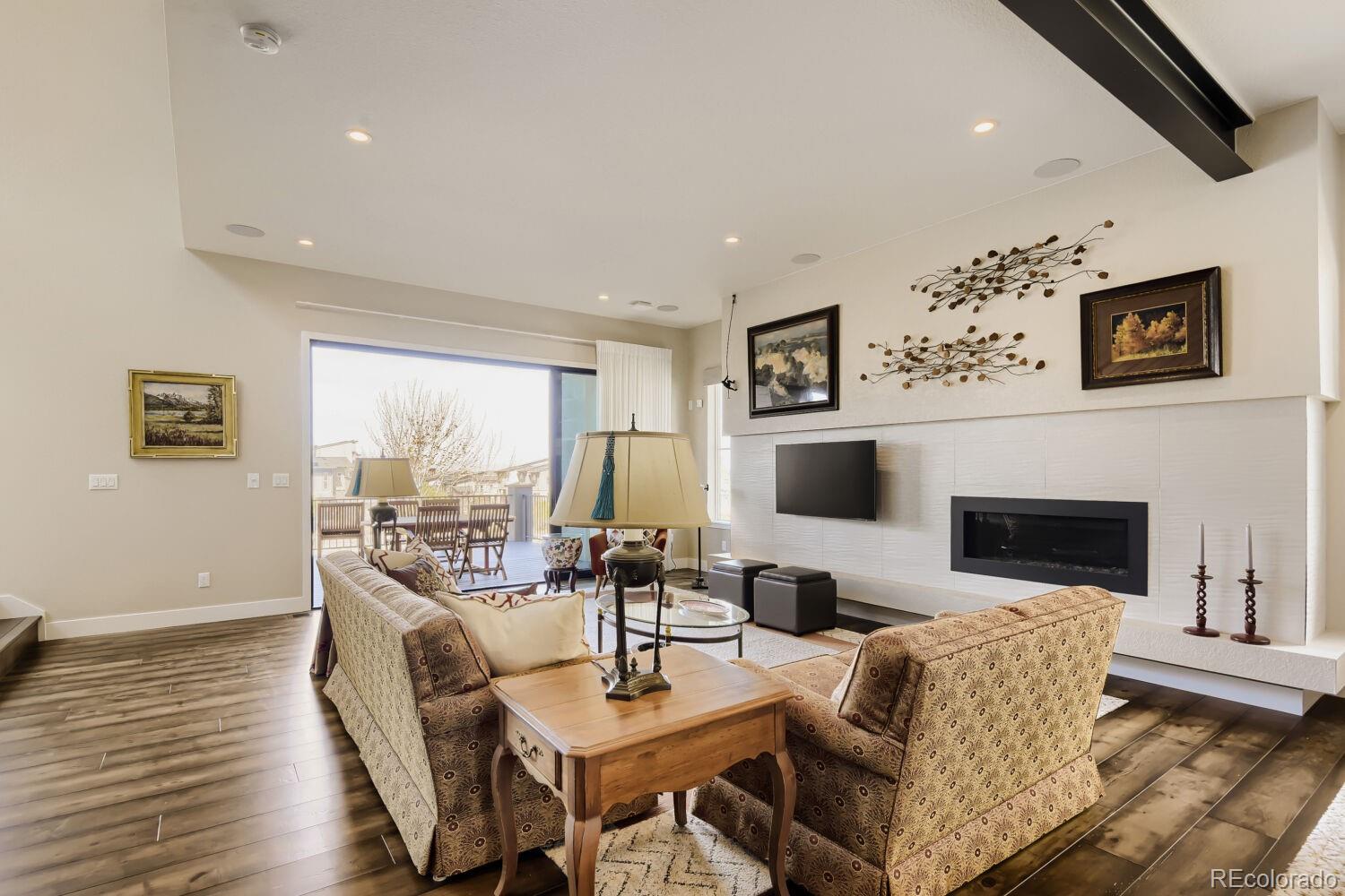 10155 Bellwether Lane Lone Tree, CO 80124 - Photo 15 of 45 a living room with fireplace furniture and a flat screen tv