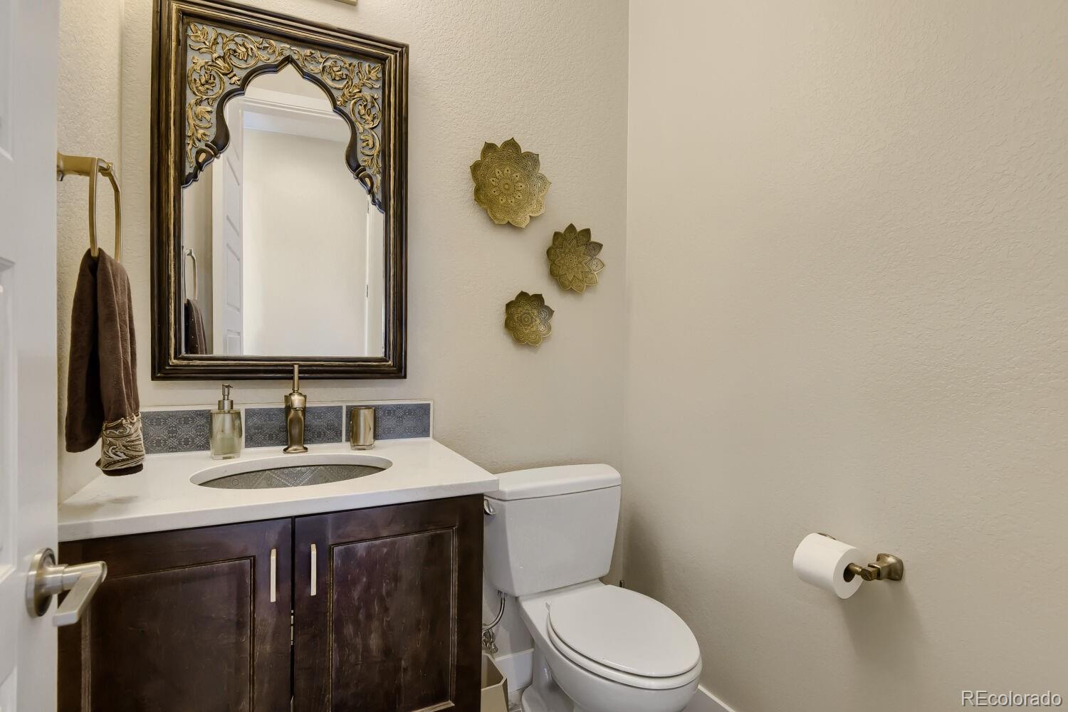 10155 Bellwether Lane Lone Tree, CO 80124 - Photo 19 of 45 a bathroom with a toilet sink and mirror