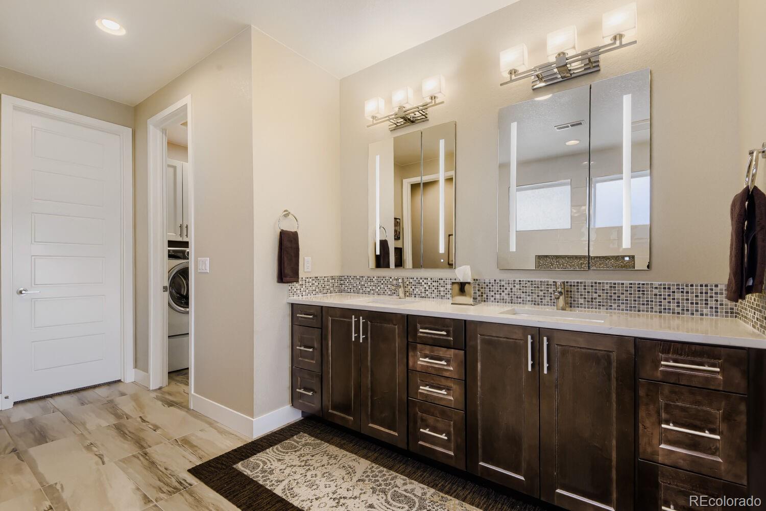 10155 Bellwether Lane Lone Tree, CO 80124 - Photo 22 of 45 a bathroom with a granite countertop sink and a mirror