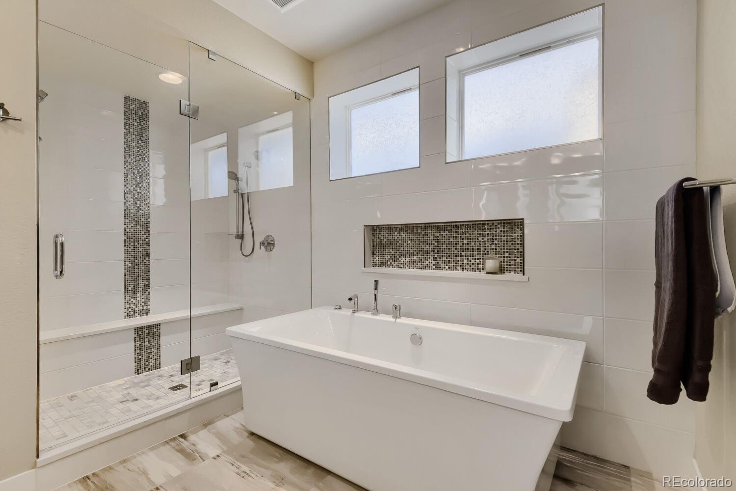 10155 Bellwether Lane Lone Tree, CO 80124 - Photo 23 of 45 a bathroom with a bathtub and a shower
