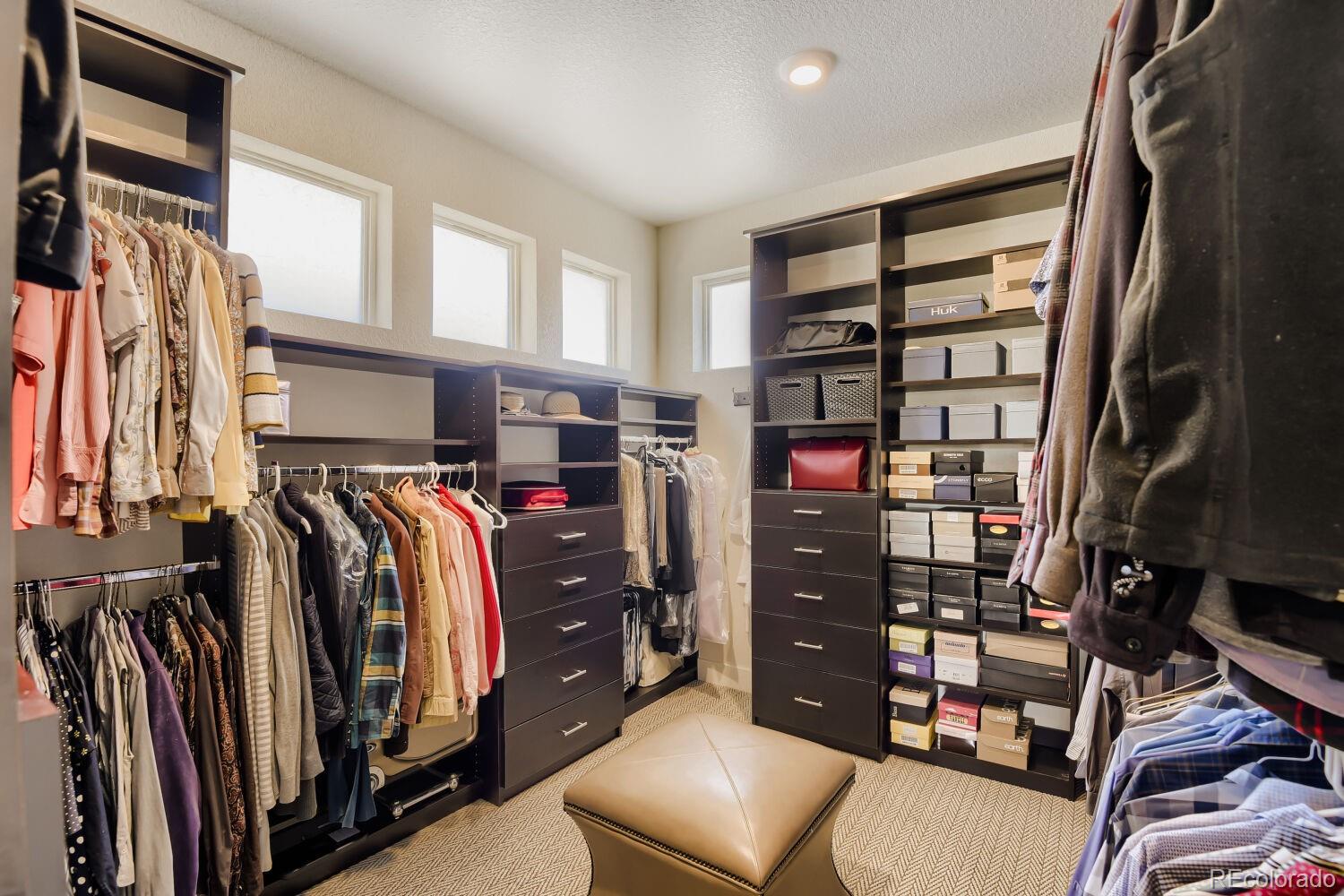 10155 Bellwether Lane Lone Tree, CO 80124 - Photo 24 of 45 a view of walk in closet with clothes and shoes