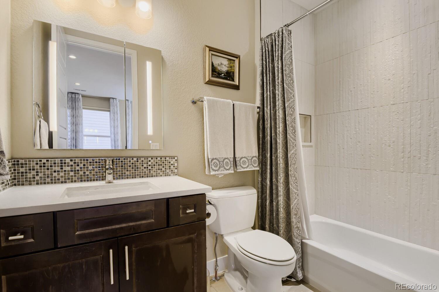 10155 Bellwether Lane Lone Tree, CO 80124 - Photo 28 of 45 a bathroom with a sink toilet vanity and shower