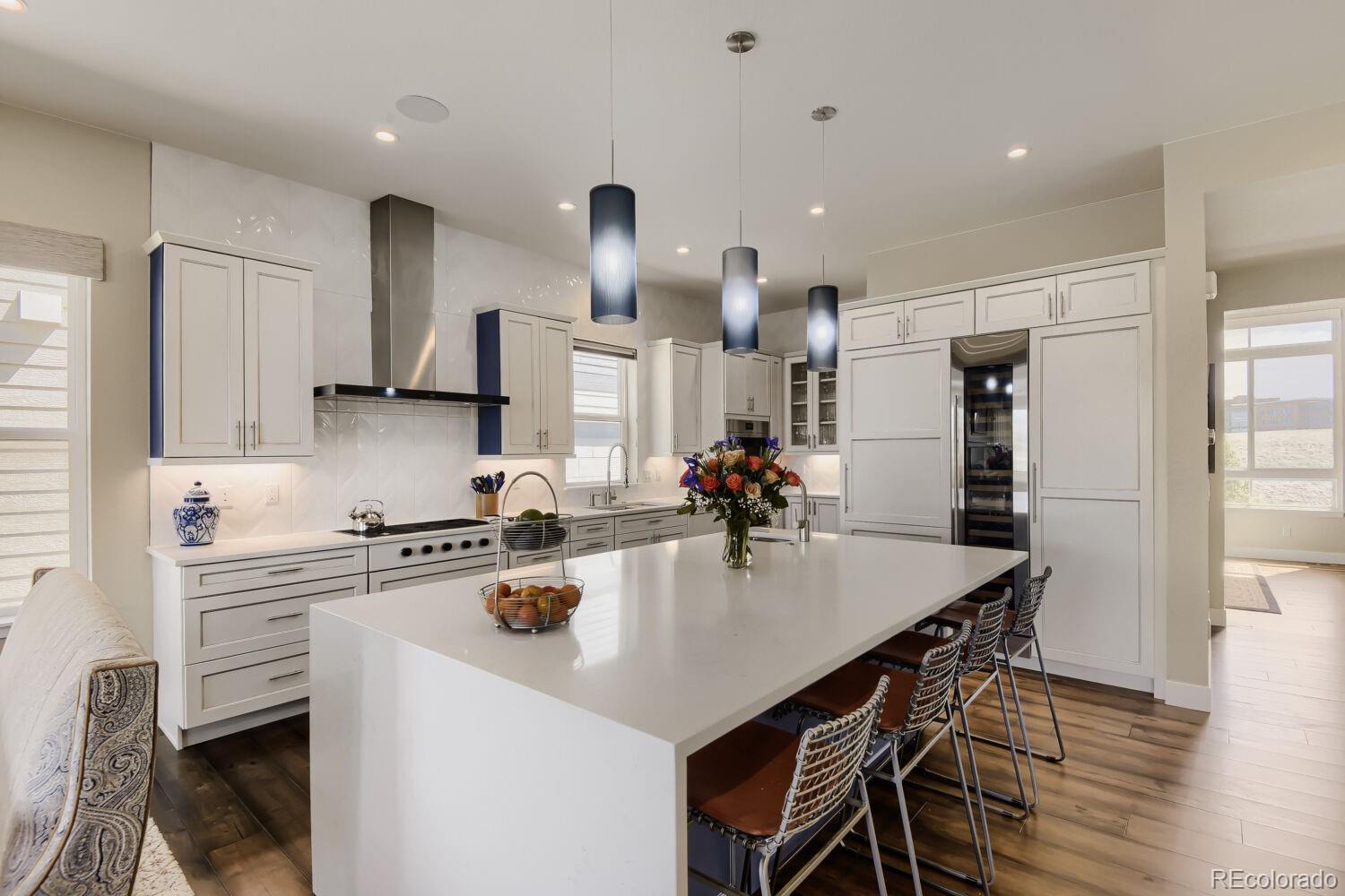 10155 Bellwether Lane Lone Tree, CO 80124 - Photo 6 of 45 a kitchen with stainless steel appliances a sink a stove a refrigerator cabinets and living room view