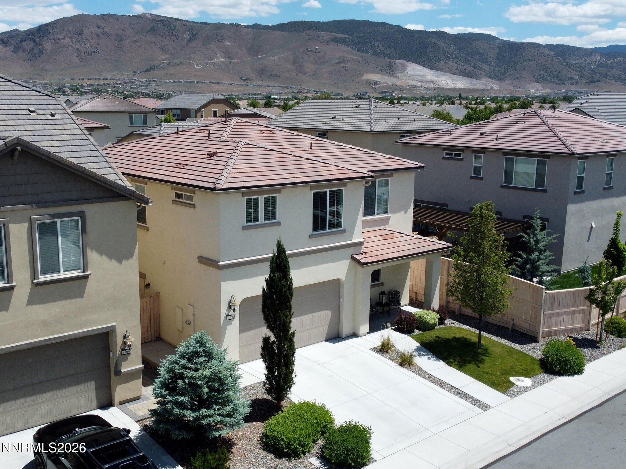 9766 Pachuca Drive Reno, NV 89521 - Photo 50 of 59 a front view of a house with a garden and mountain
