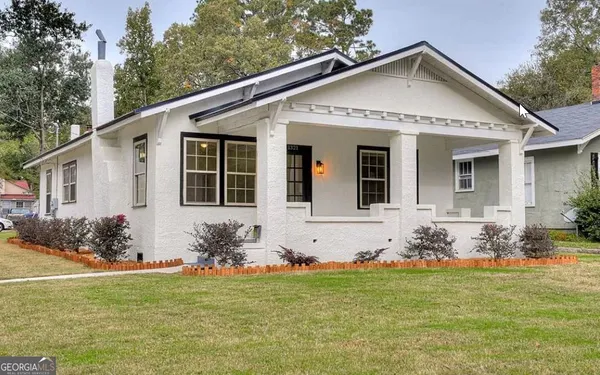 a front view of a house with garden