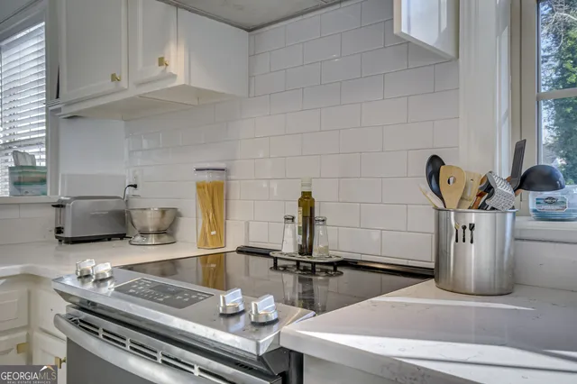 a kitchen with a sink and a stove top oven