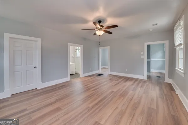 wooden floor in an empty room with a window