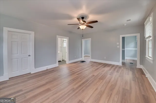 wooden floor in an empty room with a window