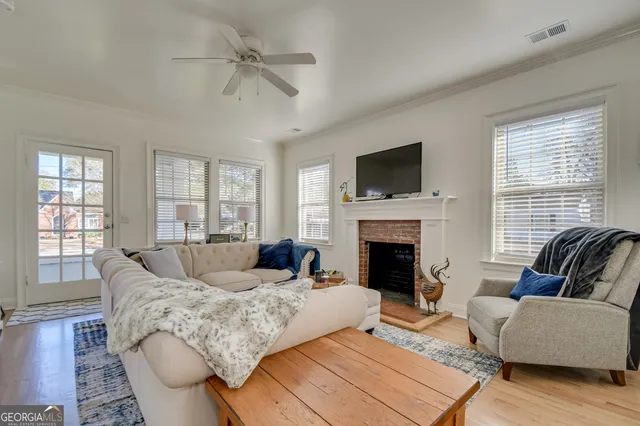 a living room with furniture a fireplace and a flat screen tv