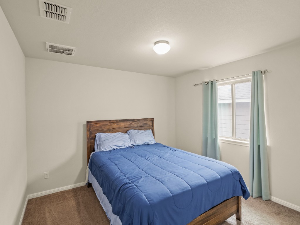 574 Nautical Loop Kyle, TX 78640 - Photo 13 of 23 a bedroom with a bed and a window