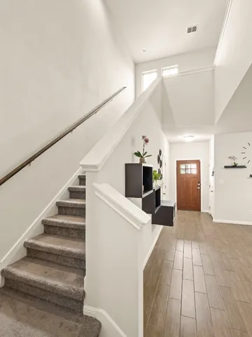 a view of a hallway view with wooden floor and staircase