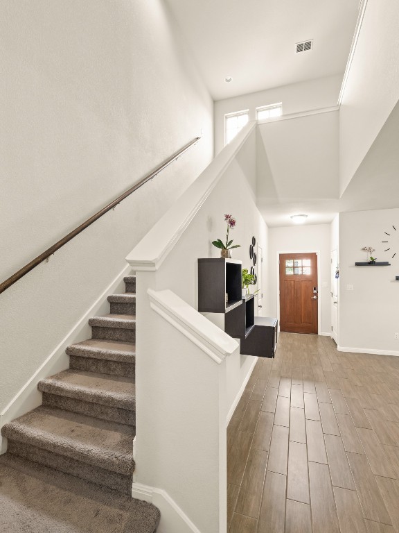 574 Nautical Loop Kyle, TX 78640 - Photo 10 of 23 a view of a hallway view with wooden floor and staircase