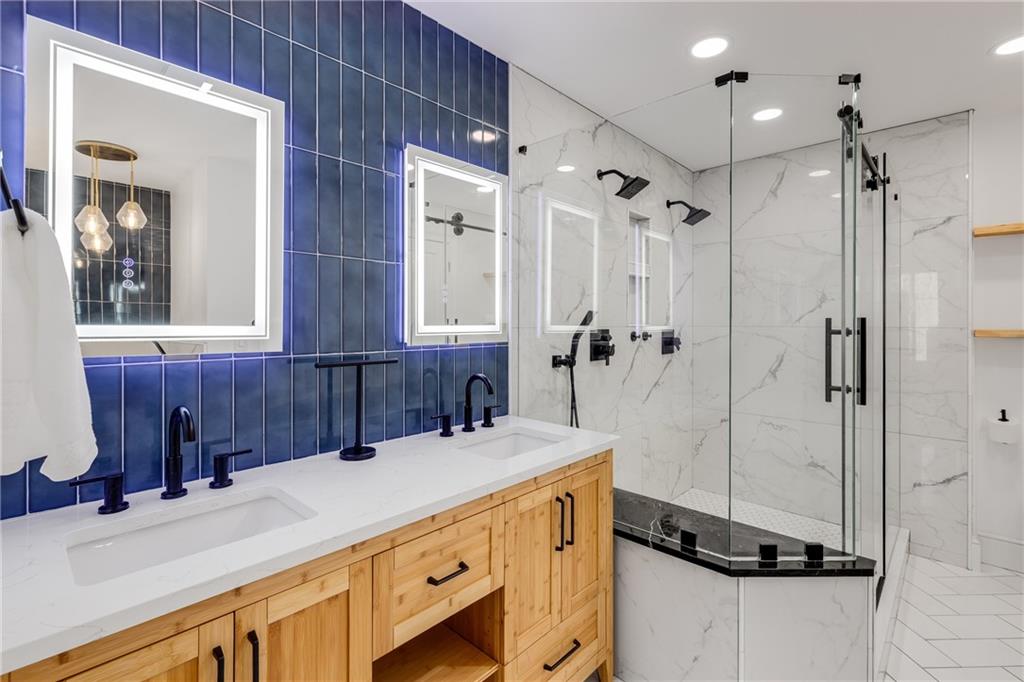 a bathroom with a sink double vanity and a shower
