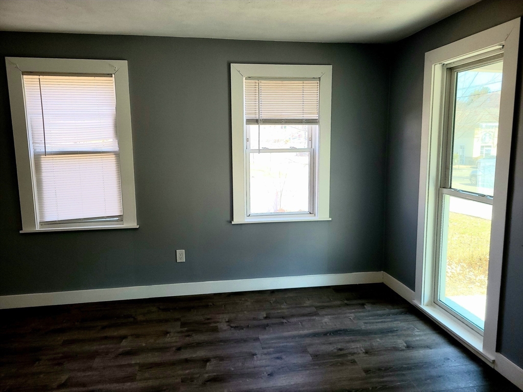 136 Commonwealth Road Wayland, MA 01778 - Photo 18 of 27 a view of an empty room with wooden floor and a window
