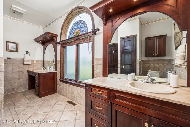 a bathroom with a sink a vanity and a mirror