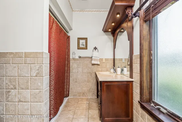a bathroom with a sink a mirror and shower