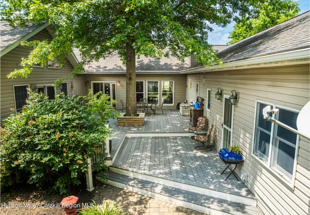 a view of backyard with outdoor seating and green space