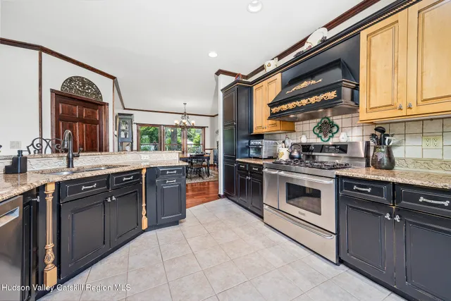 a kitchen with stainless steel appliances granite countertop a stove sink and cabinets