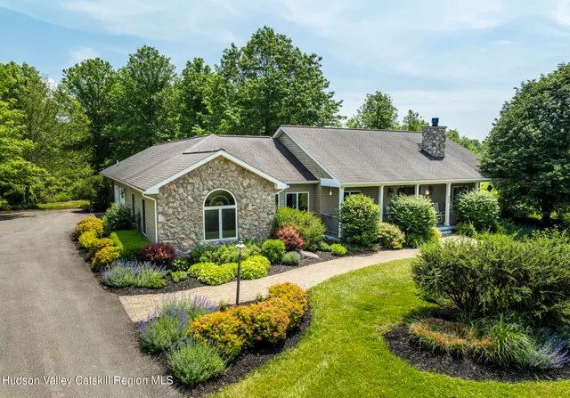 a view of a house with garden and yard
