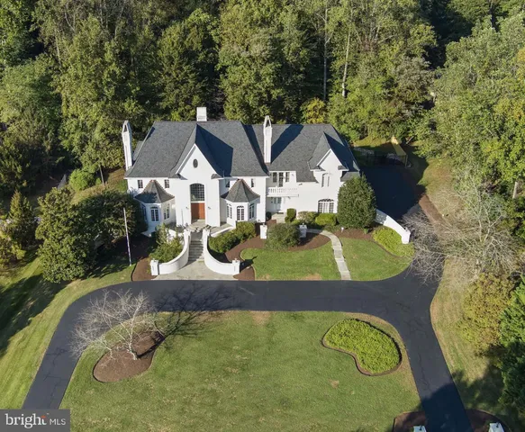 an aerial view of a house with yard swimming pool and outdoor seating