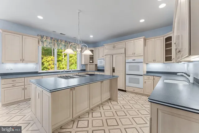 a view of an empty room with a fireplace and a window