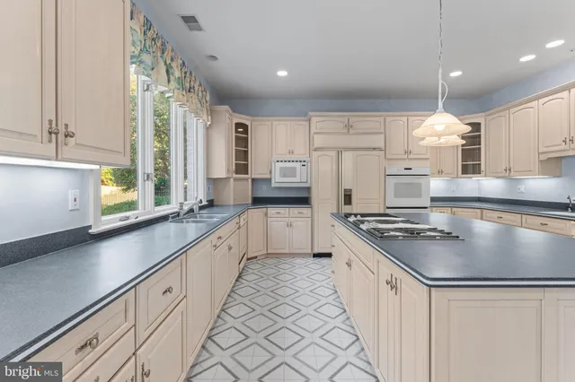 an empty room with windows and fireplace