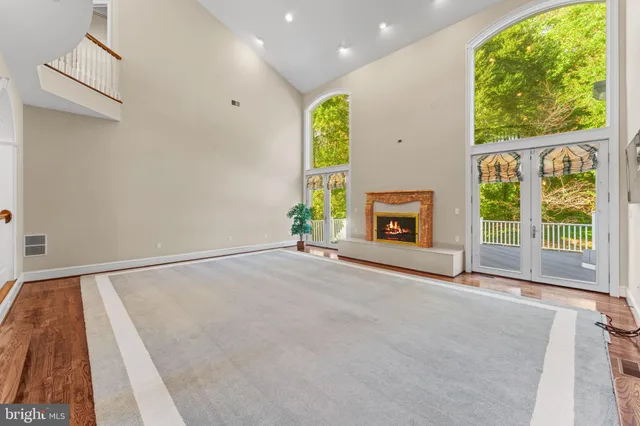 a view of empty room with wooden floor and window