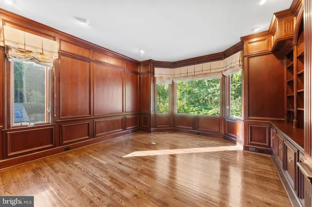 a view of a big room with wooden floor and a bathroom