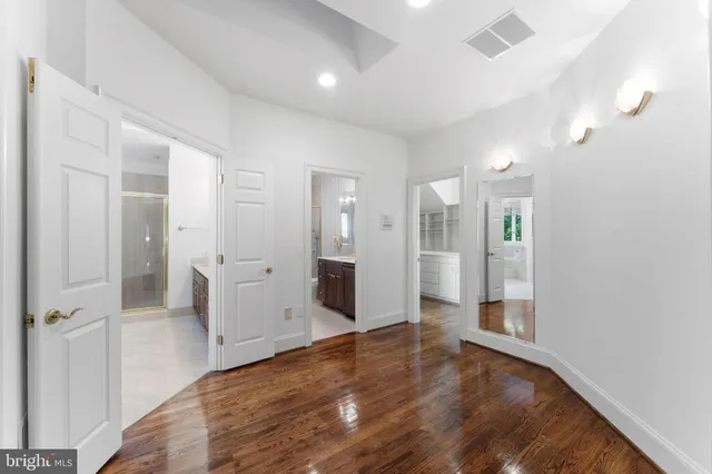 a view of an empty room with wooden floor