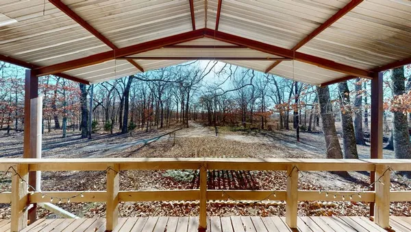 a view of a water pond with trees in the background