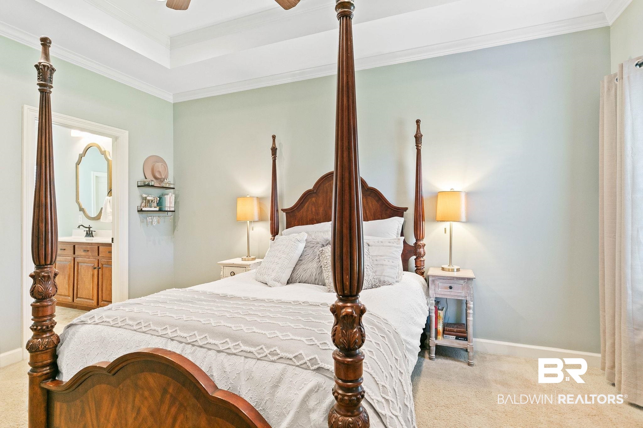 9522 Sanibel Loop Daphne, AL 36526 - Photo 21 of 43 Bedroom with crown molding, light carpet, ceiling fan, connected bathroom, and a tray ceiling