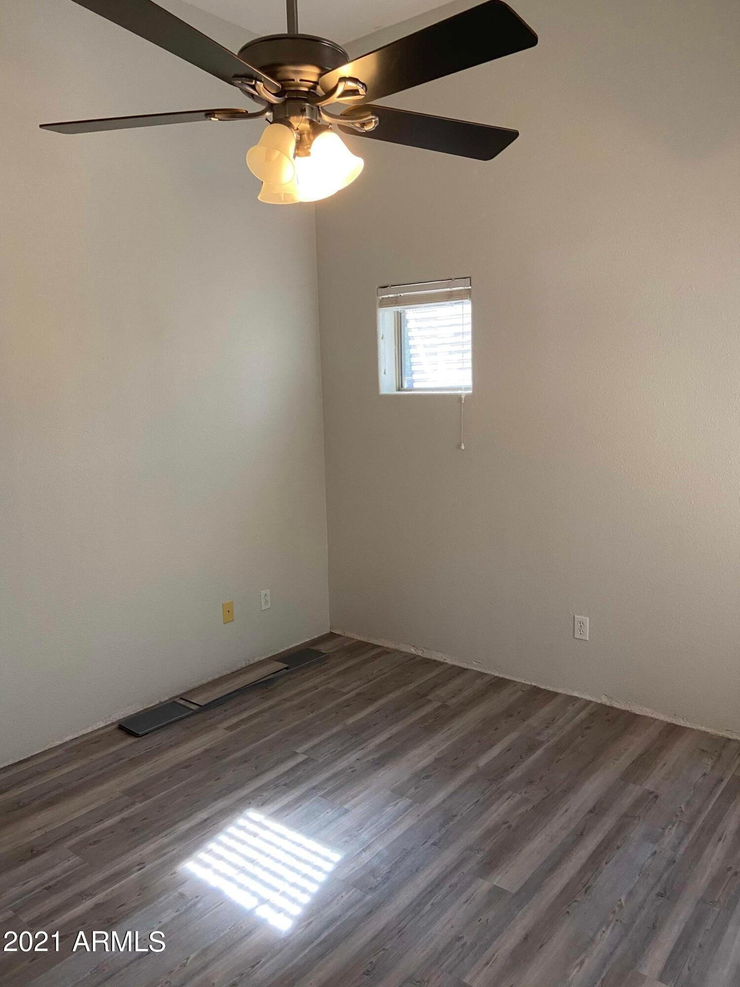 2929 North 37th Street, Unit 1 Phoenix, AZ 85018 - Photo 12 of 17 a view of a small space with wooden floor and a window