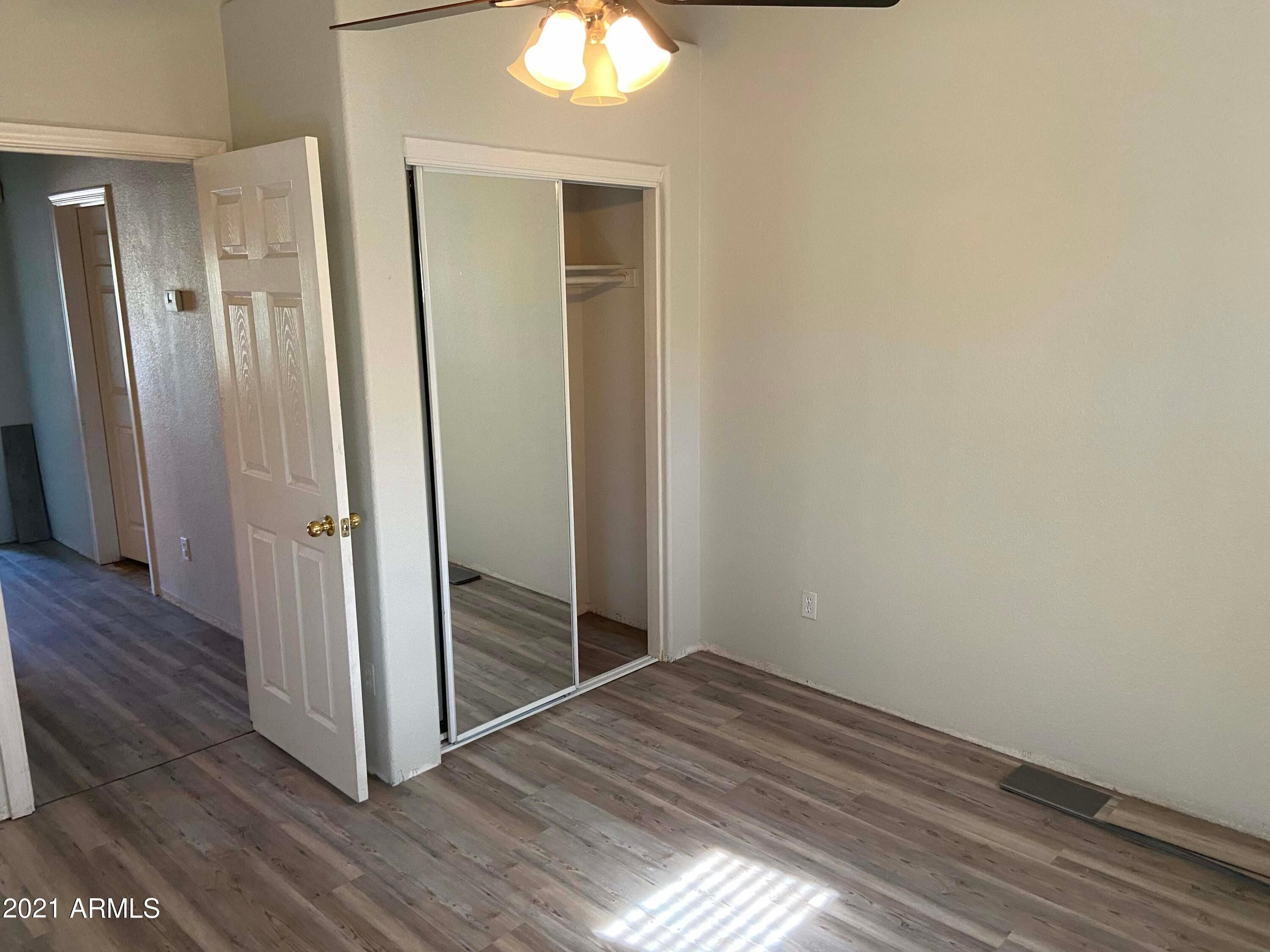 2929 North 37th Street, Unit 1 Phoenix, AZ 85018 - Photo 13 of 17 an empty room with wooden floor