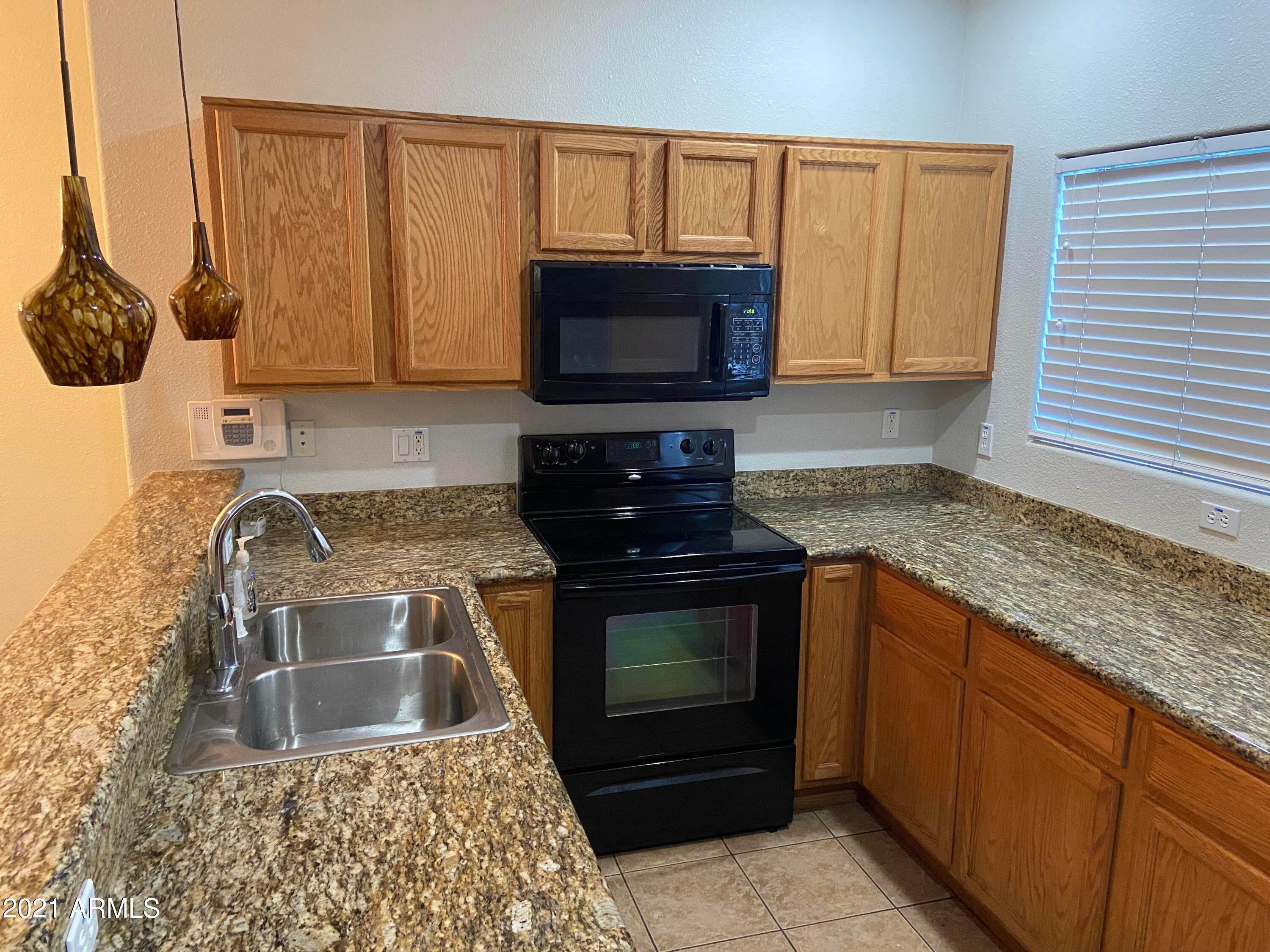 2929 North 37th Street, Unit 1 Phoenix, AZ 85018 - Photo 4 of 17 a kitchen with granite countertop a stove a sink and a granite counter tops