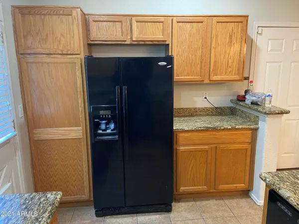 a kitchen with a refrigerator and cabinets