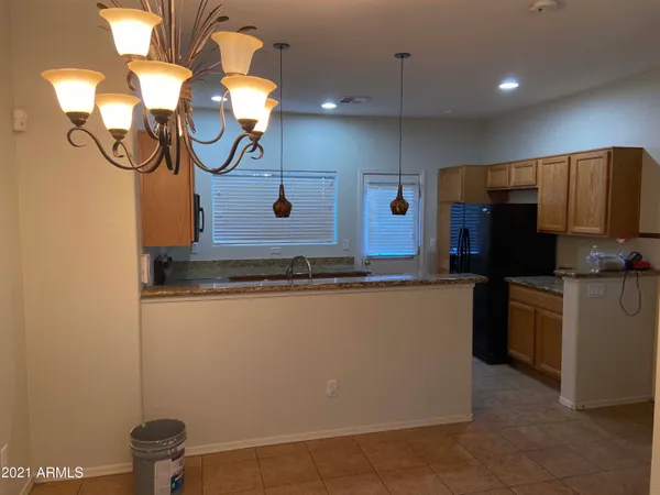 a kitchen with a refrigerator and a stove