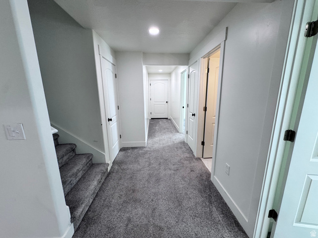 4729 Middleboro Road Herriman, UT 84096 - Photo 9 of 19 Hallway with textured gray carpeting, white walls, and recessed lighting