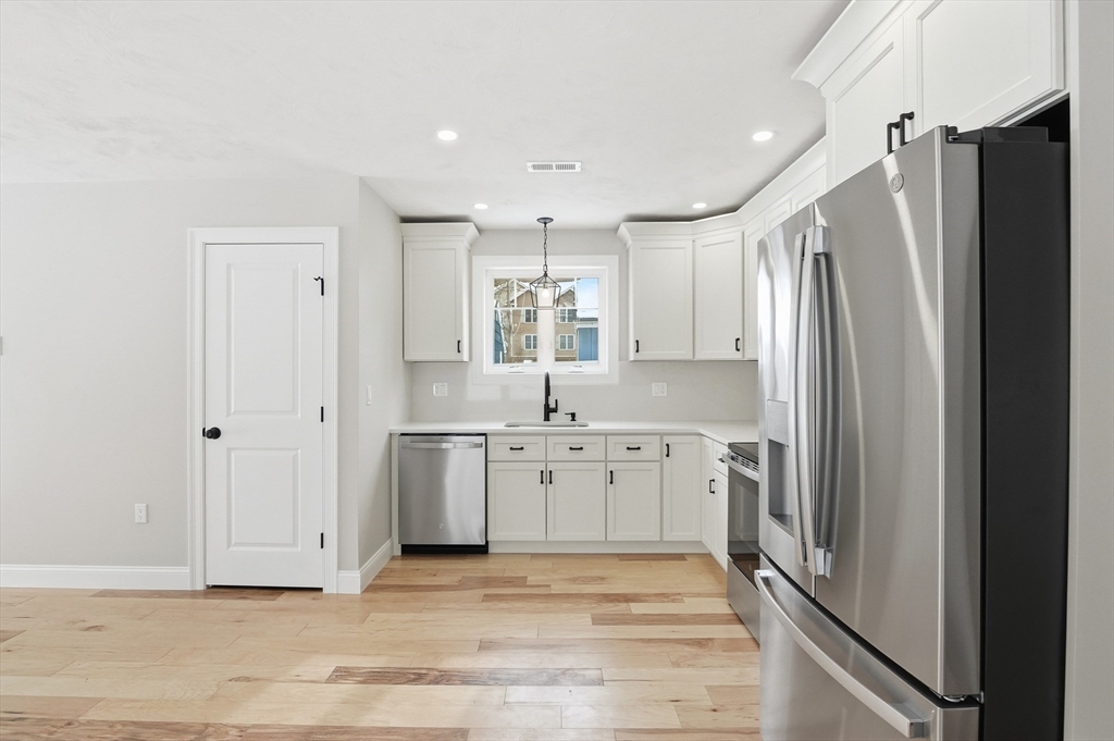 12 Benham Street Worcester, MA 01604 - Photo 3 of 26 a large kitchen with a refrigerator and a sink