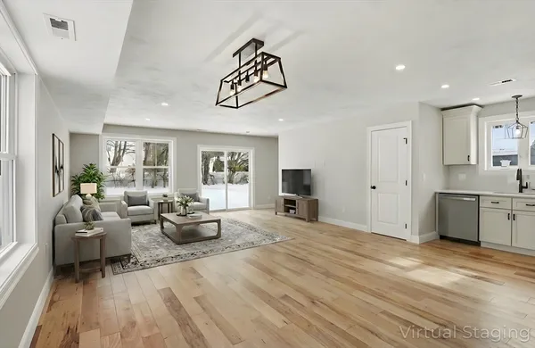 a view of a living room kitchen with furniture and window