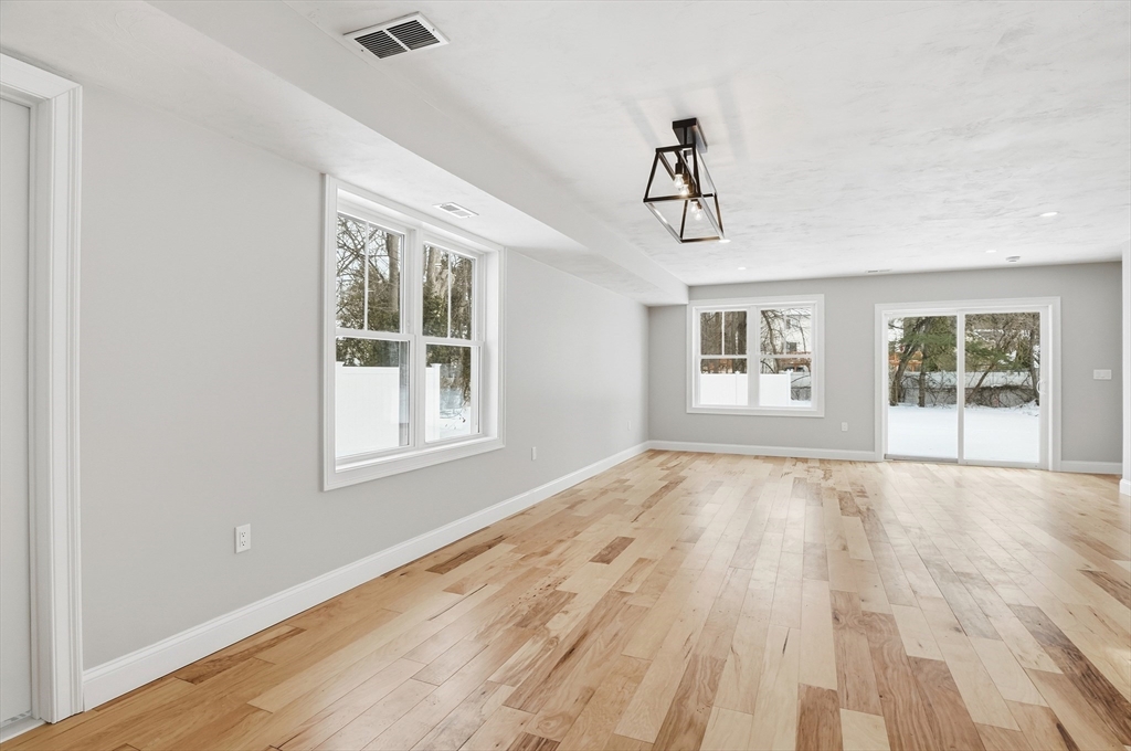 12 Benham Street Worcester, MA 01604 - Photo 6 of 26 a view of an empty room with wooden floor and window
